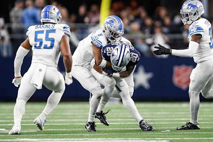 Detroit Lions safety Ifeatu Melifonwu (6) tackles Dallas Cowboys running back Tony Pollard (20) during the second half at AT&T Stadium in Arlington, Texas on Saturday, Dec. 30, 2023.